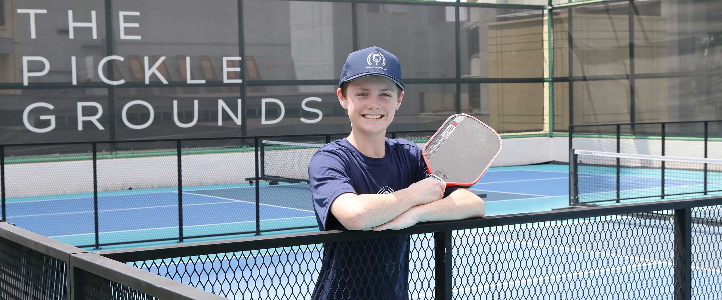 Austin Romaguera lunging for a low forehand at a professional pickleball tournament